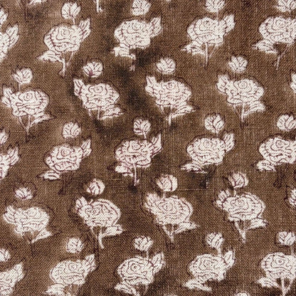 Floral pattern on fabric with white flowers on a brown background