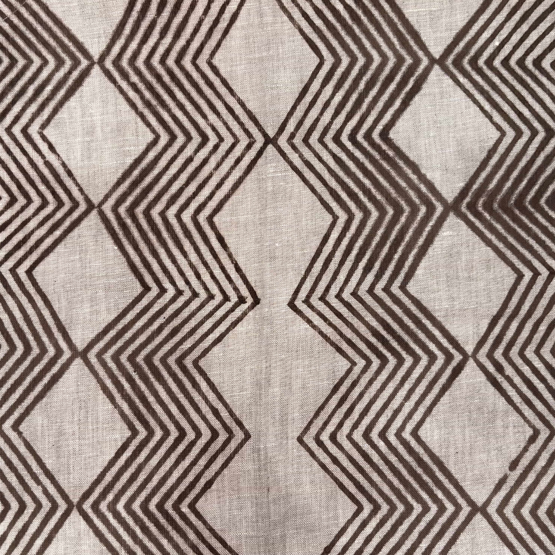 Textile with brown zigzag pattern on a grey background