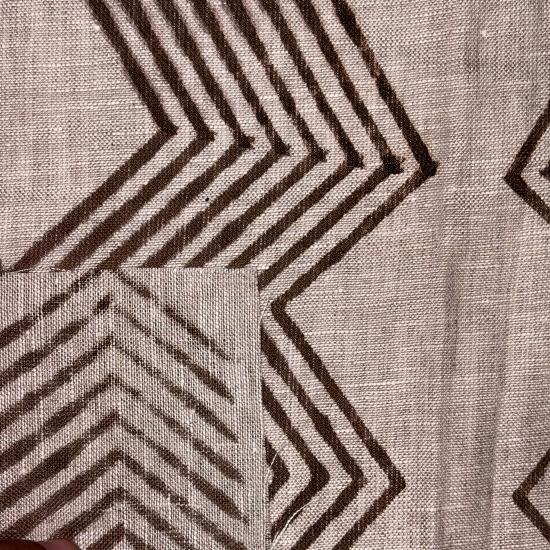 Textile with brown geometric pattern on a grey background