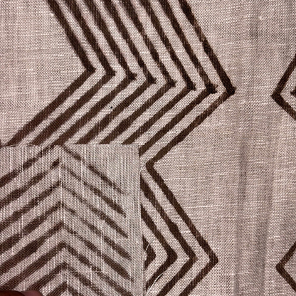 Textile with brown geometric pattern on a grey background