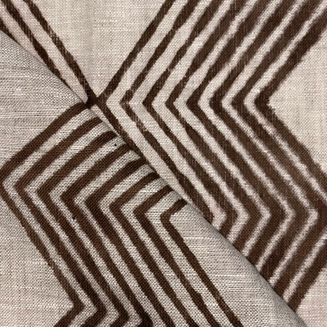 Close-up of fabric with brown zigzag pattern on grey background