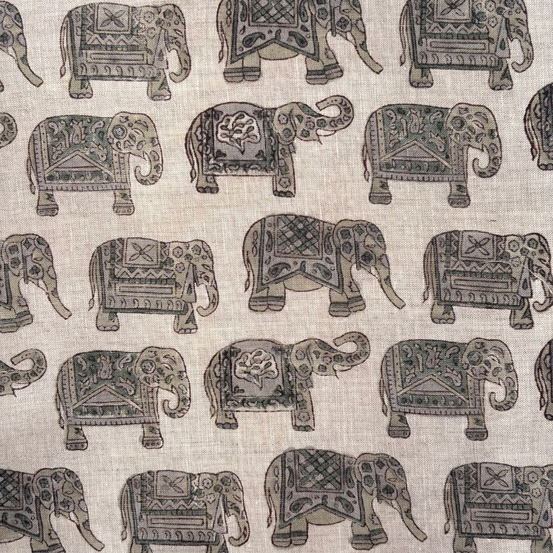 Pattern of decorative elephants on a grey fabric background