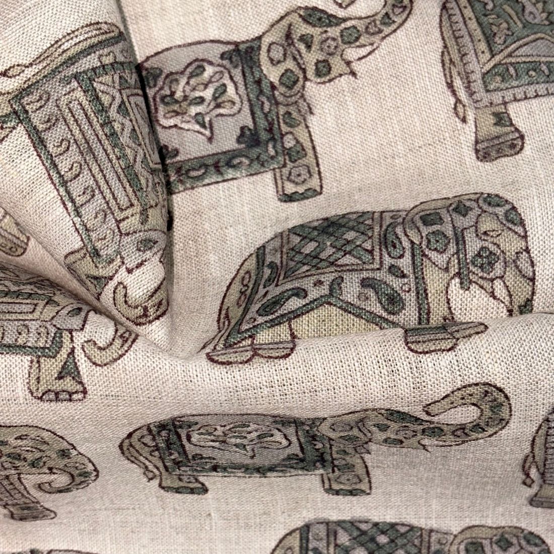 Patterned fabric with elephant designs on a grey  background