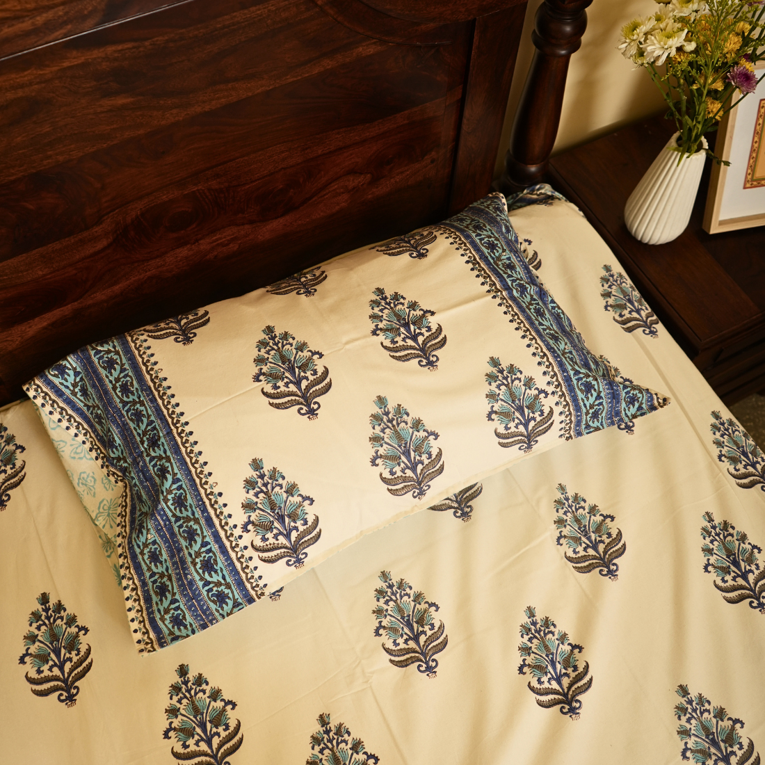 White fabric with floral patterns on a wooden bed frame