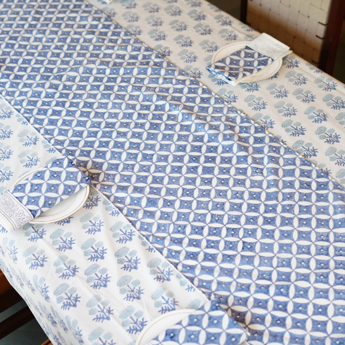 Blue and white patterned table linen set on a wooden table