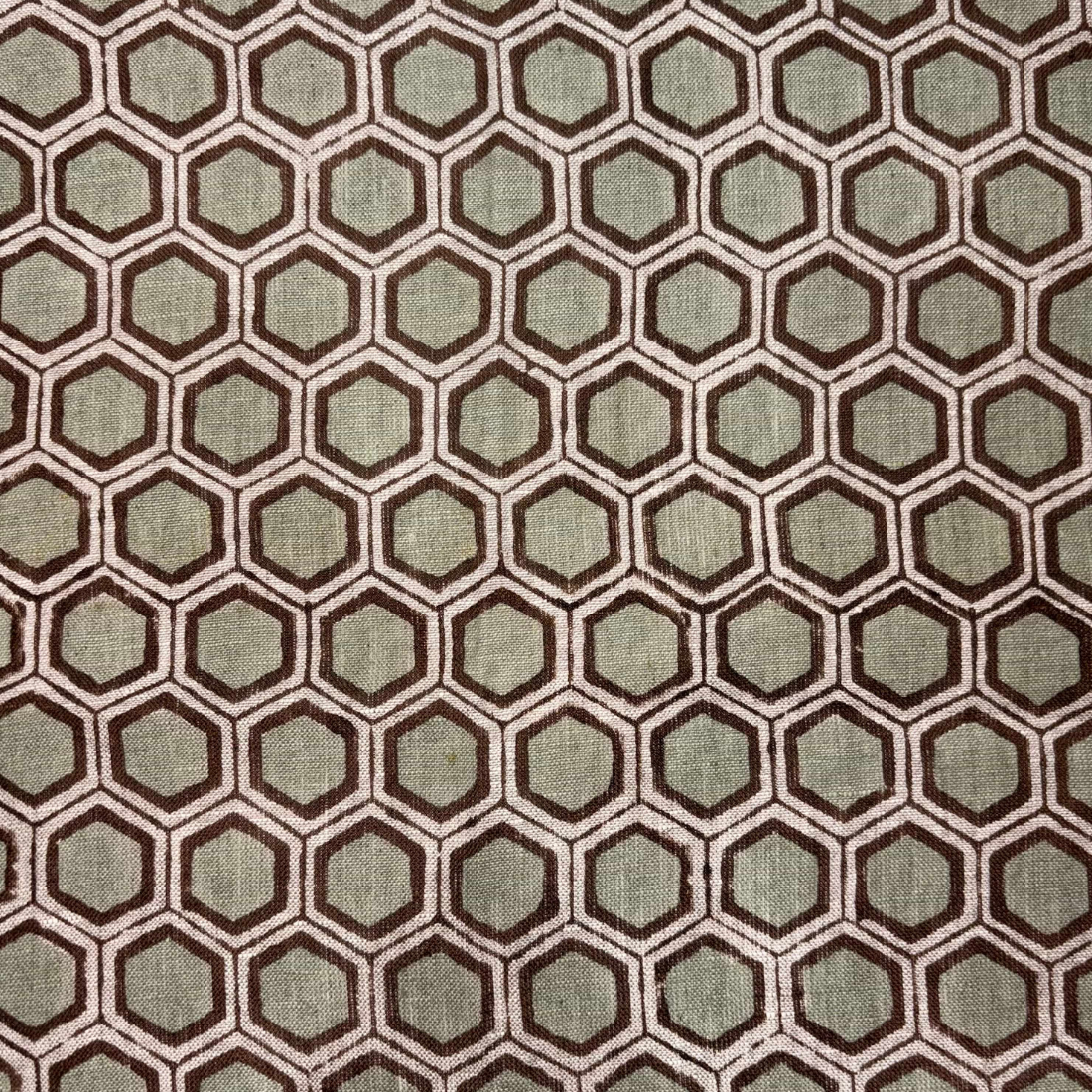 Hexagonal pattern fabric swatch in brown and green