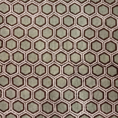 Hexagonal pattern fabric swatch in brown and green