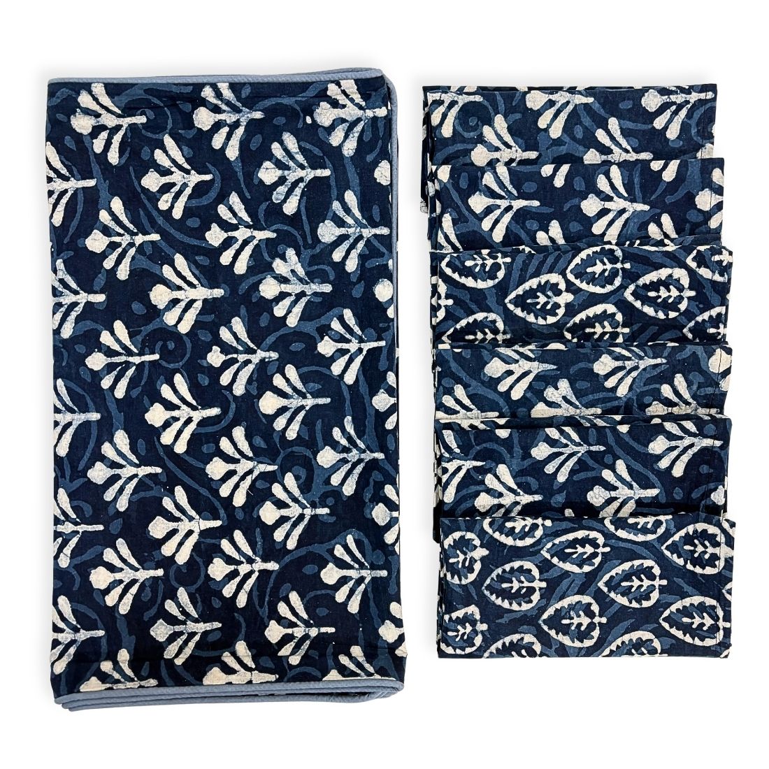 Table runner and napkins with blue and white pattern on a white background