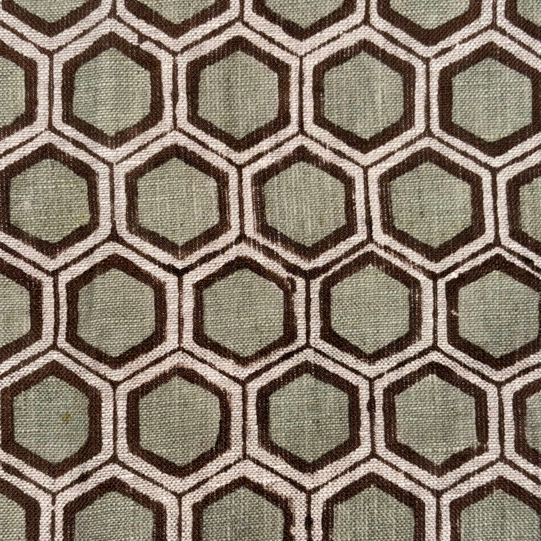 Hexagonal pattern fabric swatch with brown and green colors
