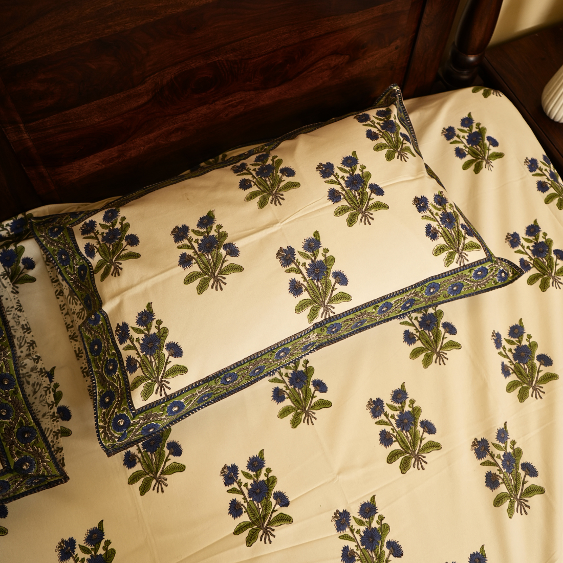 Floral patterned fabric with embroidered designs on a wooden surface