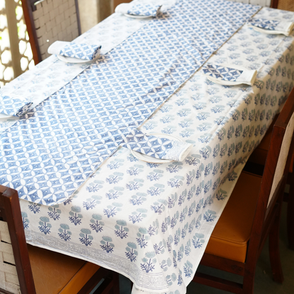 Dining table with a blue and white patterned table linen set