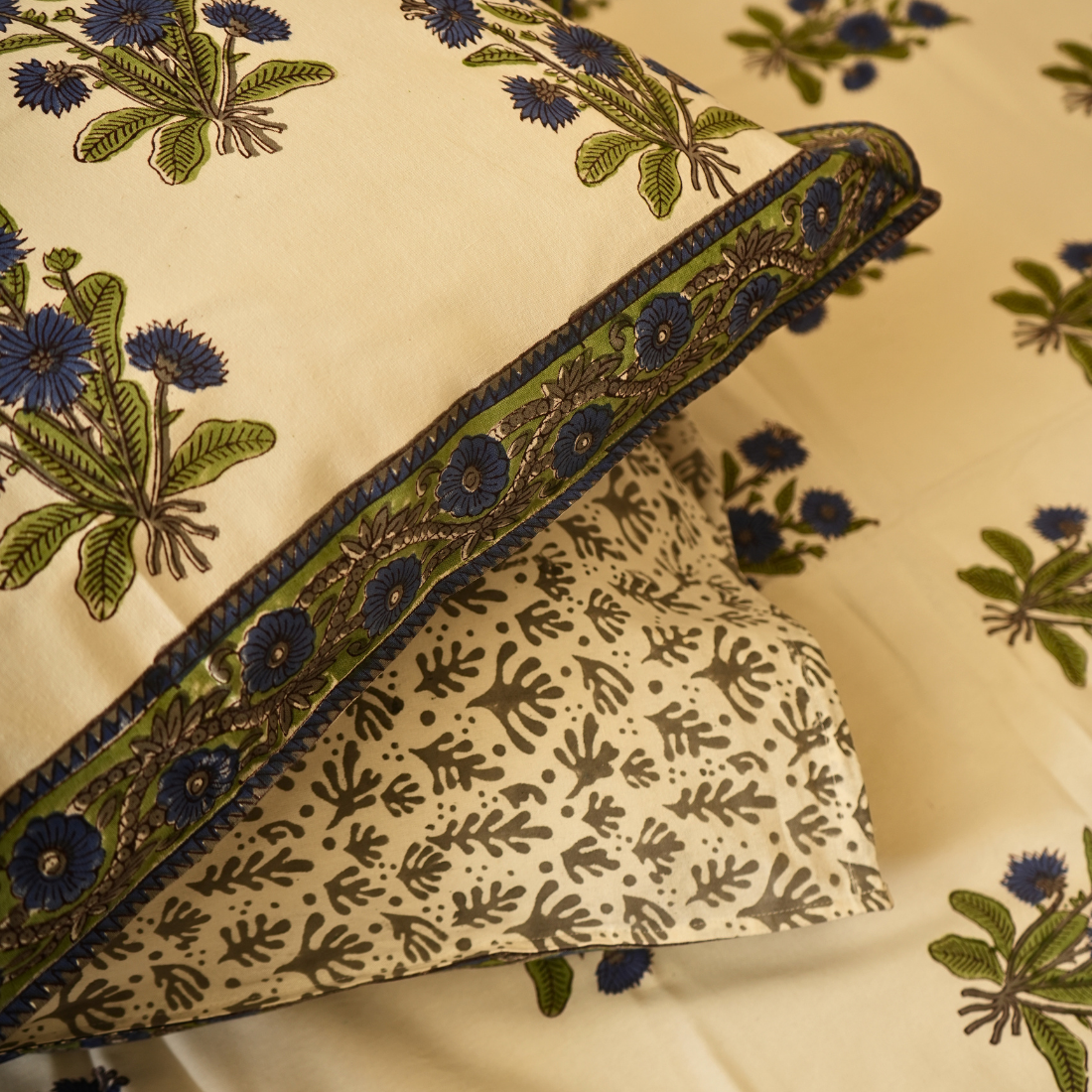 Decorative fabric with floral patterns and embroidered border on a beige background
