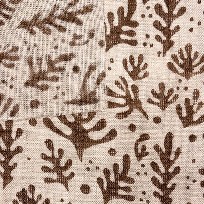 Textile with brown leaf pattern on beige background