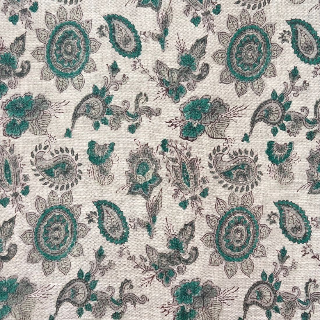 Patterned fabric with green and gray designs on a grey background