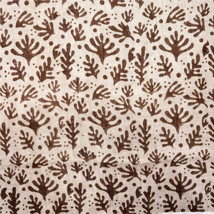 Patterned fabric with brown leaf-like shapes on a beige background
