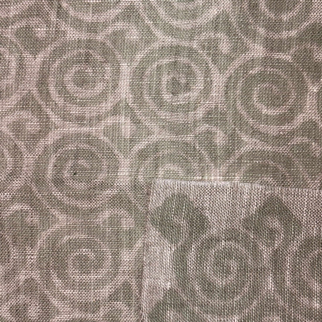 Textured fabric with a subtle pattern on a gray background