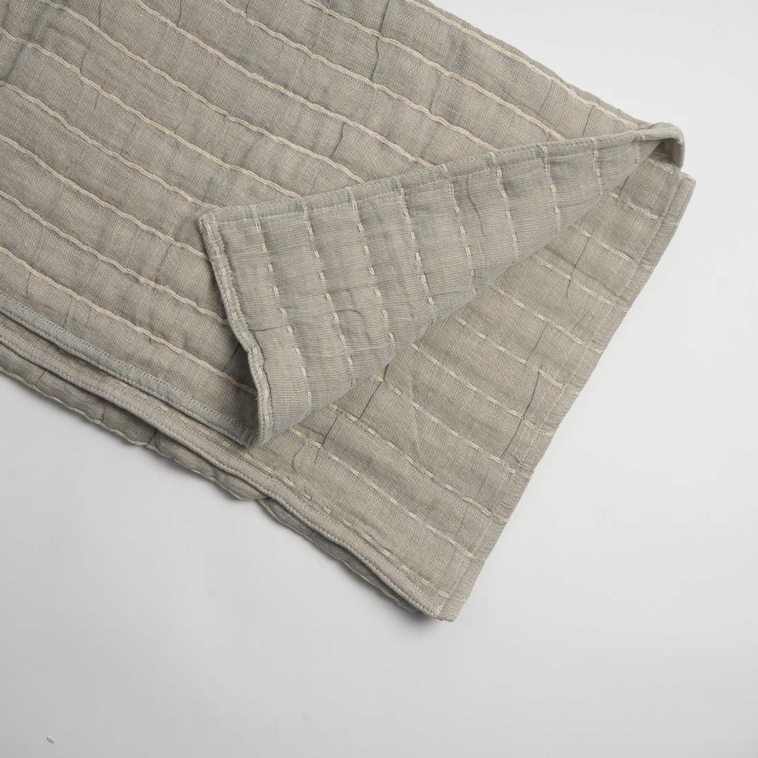 Folded beige fabric on a white background