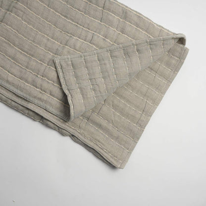 Folded beige fabric on a white background
