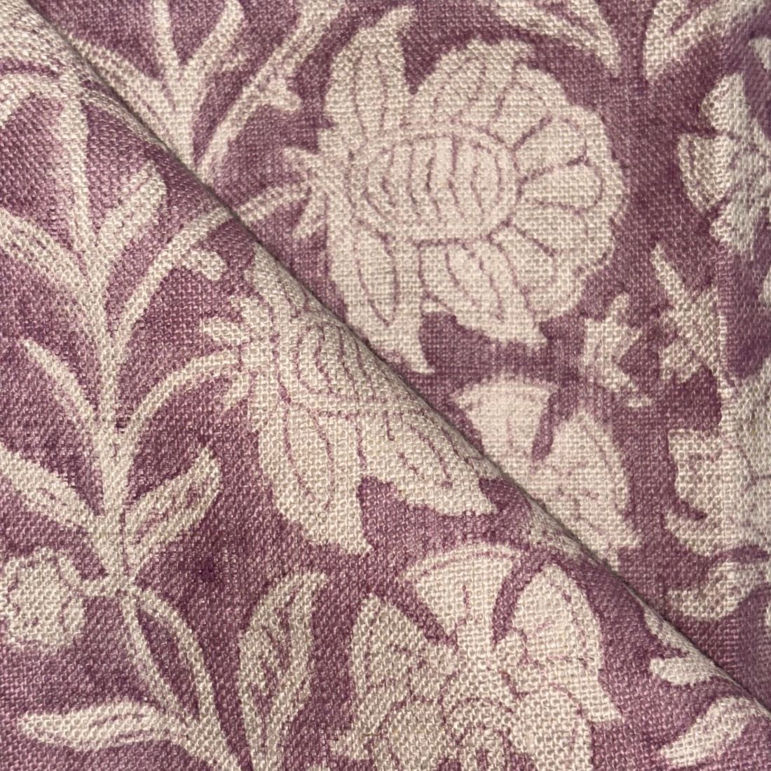 Close-up of fabric with floral pattern on a purple background