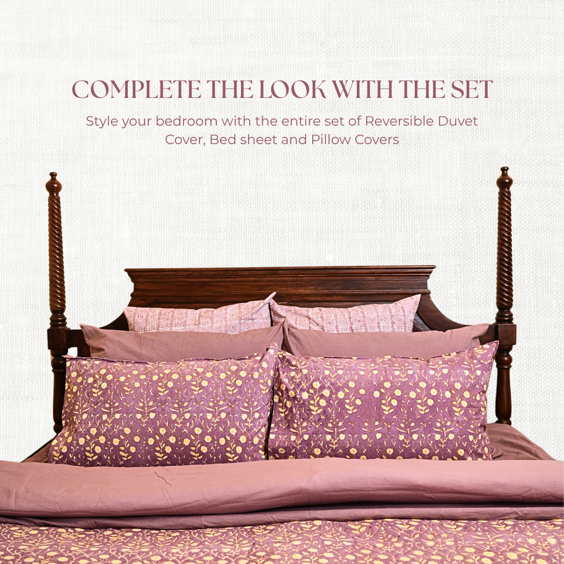 Bed with purple floral bedding set on a white background