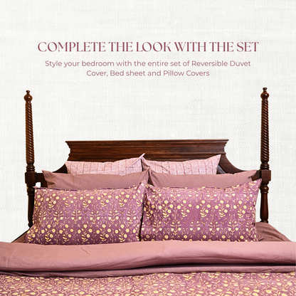Bed with purple floral bedding set on a white background