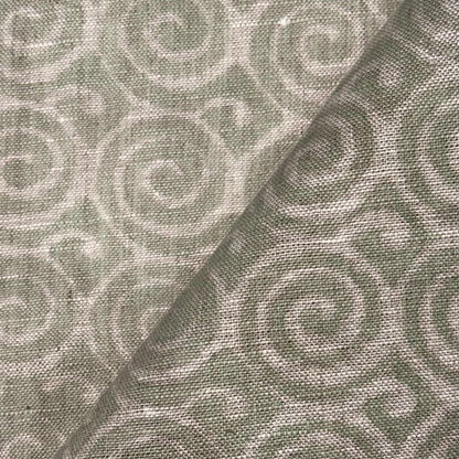 Fabric with a subtle pattern of interlocking shapes in shades of gray.