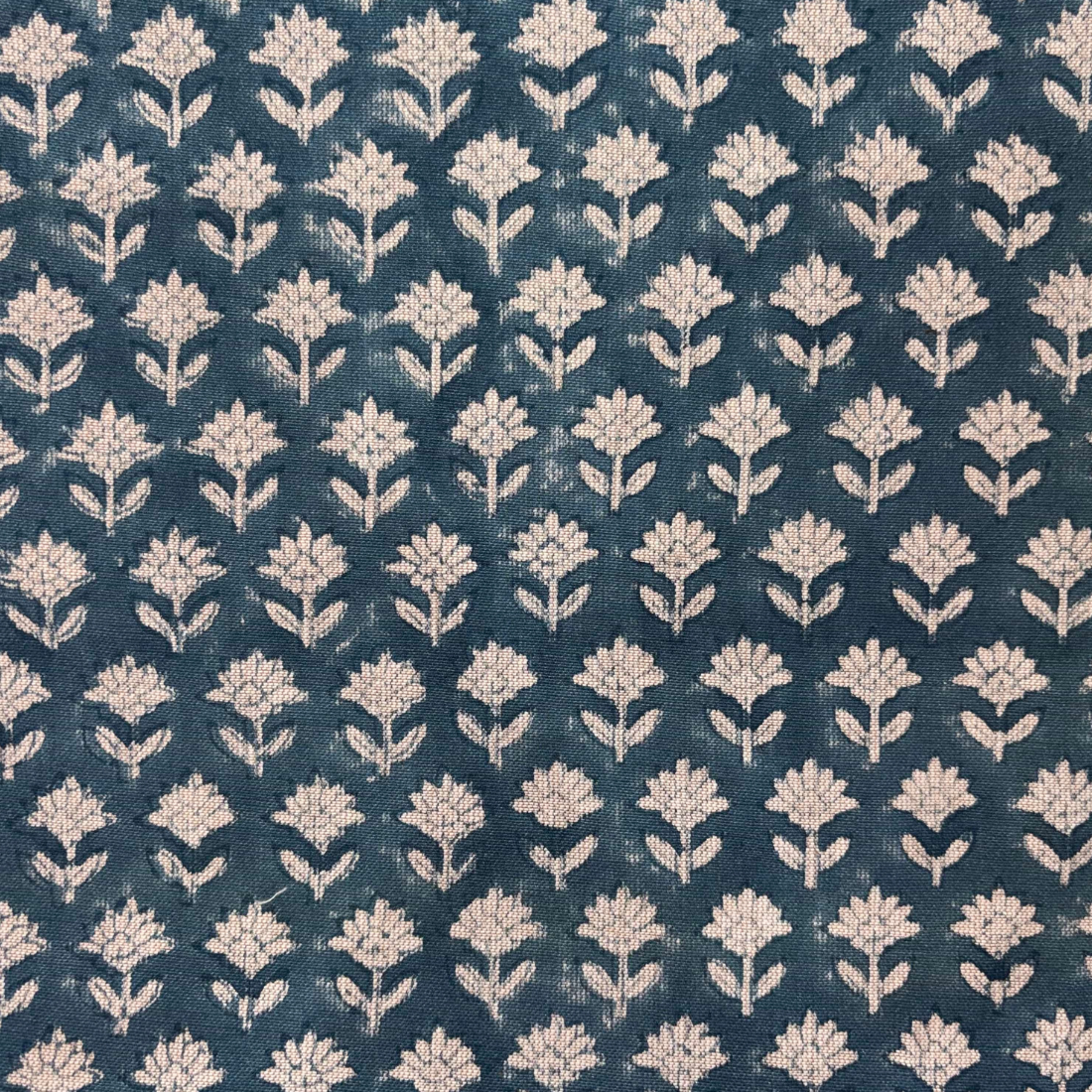 Patterned fabric with white floral design on a blue background