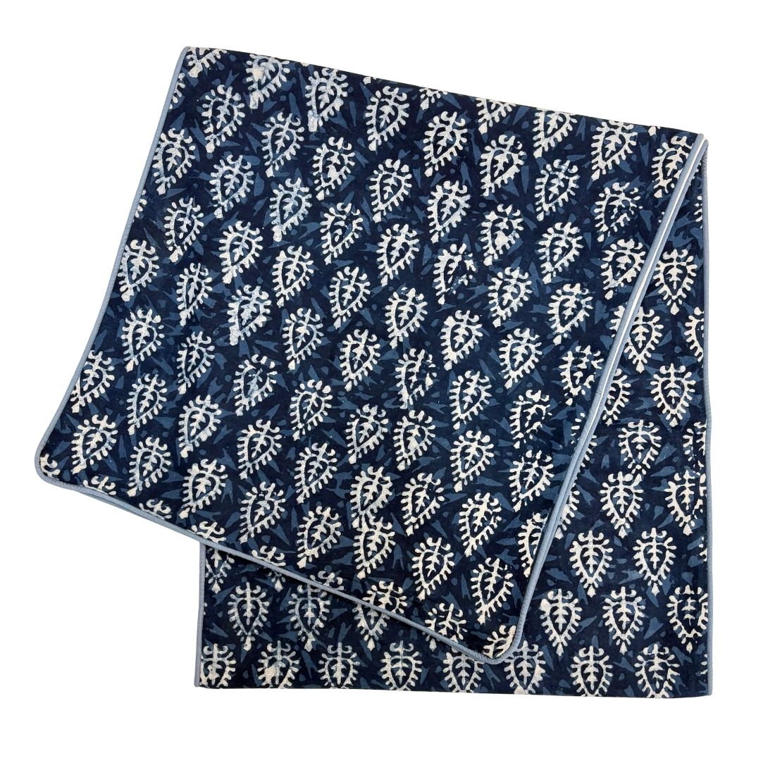 Folded fabric with blue and white pattern on a white background