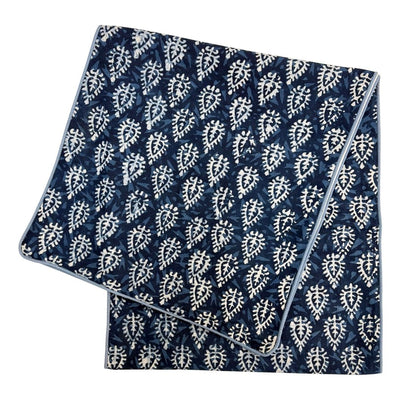 Folded fabric with blue and white pattern on a white background