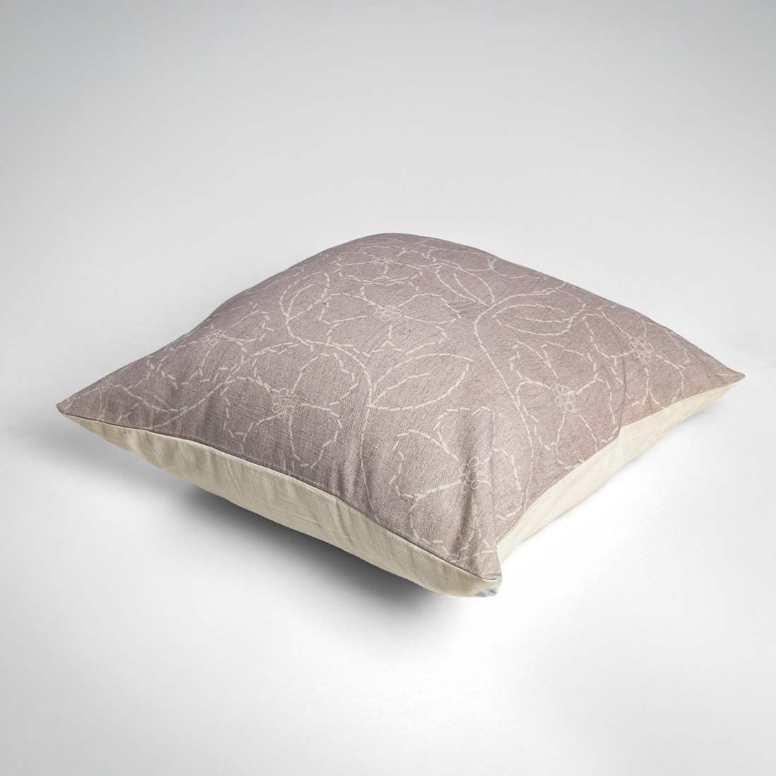 Decorative pillow with a subtle pattern on a white background