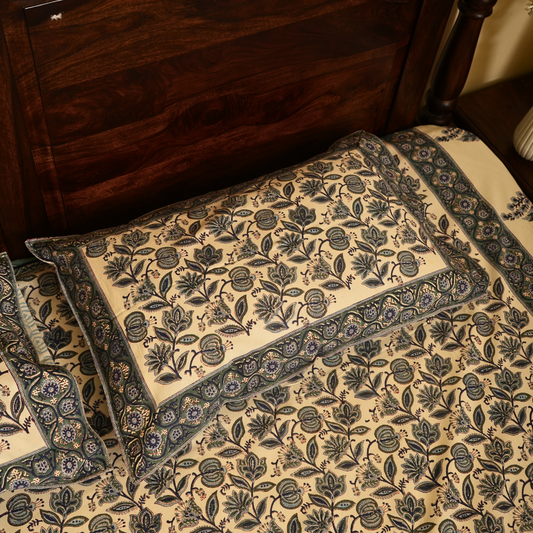 Set of floral-patterned Pllow in front of a wooden piece of furniture.