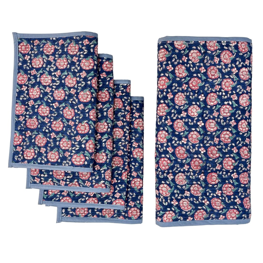 Set of floral table runner and placemats with pink flowers on a blue background