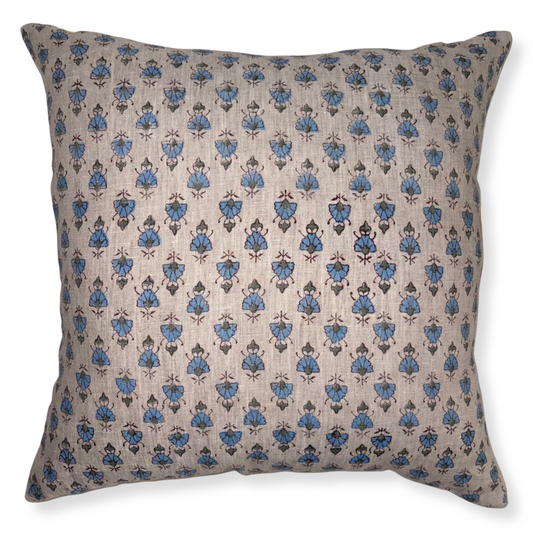Decorative pillow with blue floral pattern on beige background
