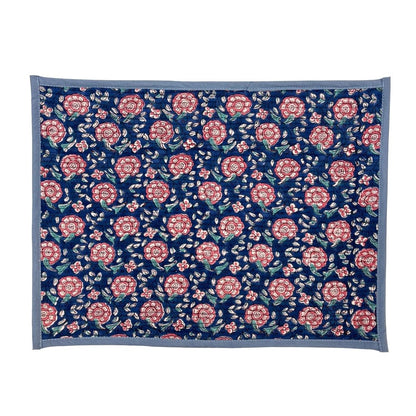Floral patterned placemat with pink flowers on a blue background