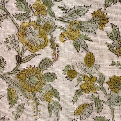 Close-up of floral fabric pattern with yellow and green flowers on a grey background