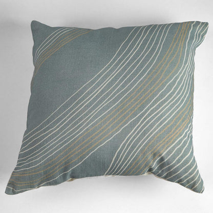 Decorative pillow with wavy line pattern on a plain background