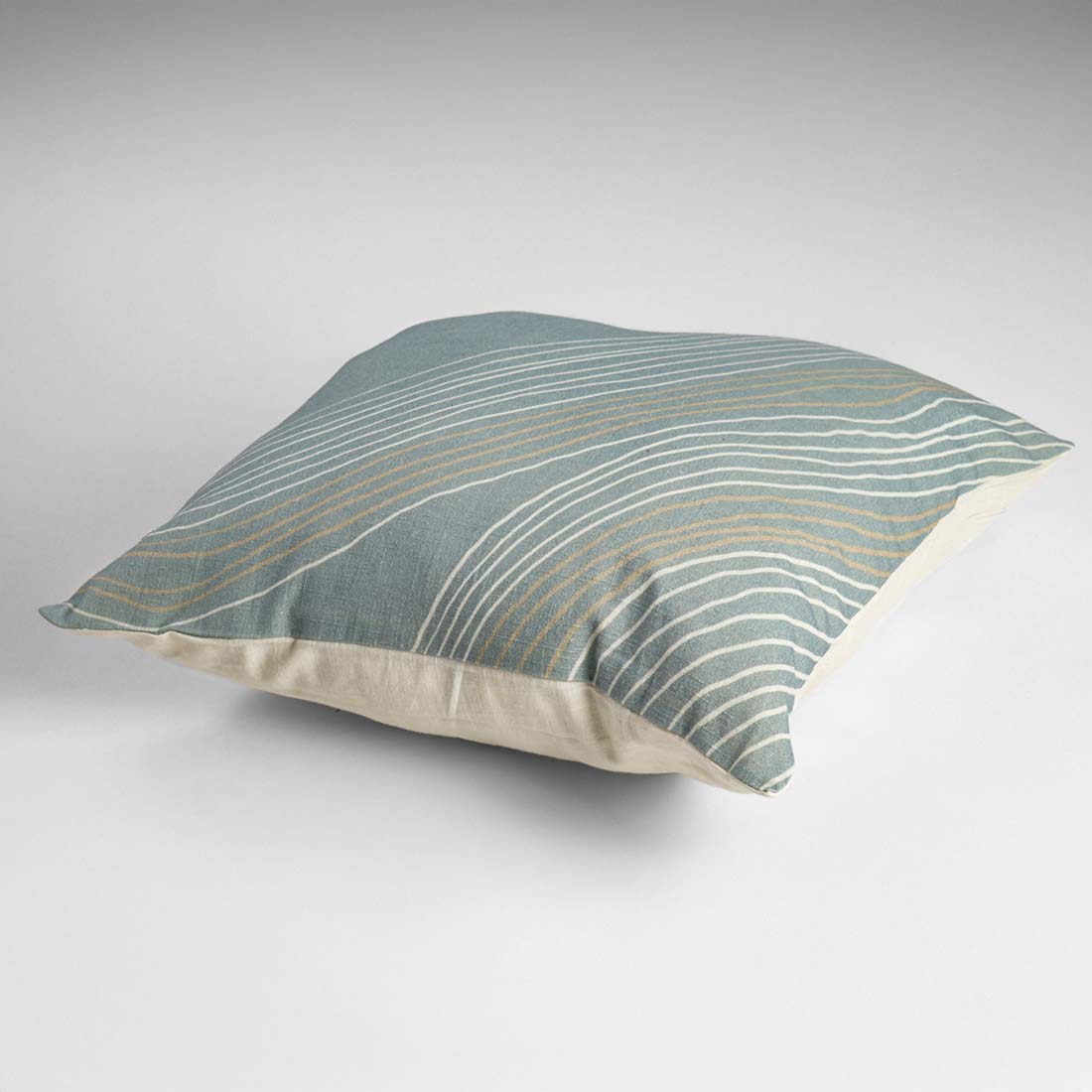 Decorative pillow with wavy pattern on a plain background