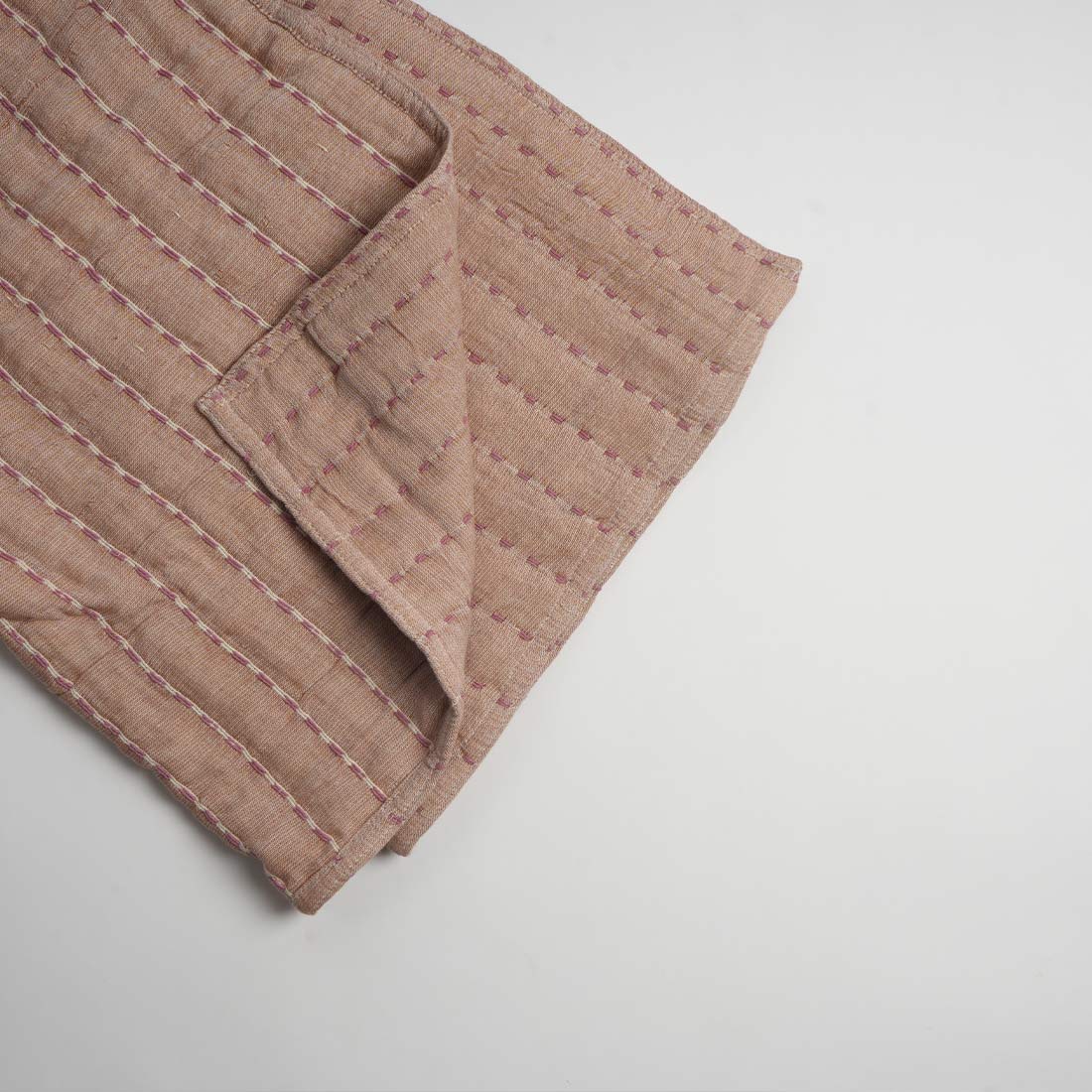 Beige throw on a light gray background