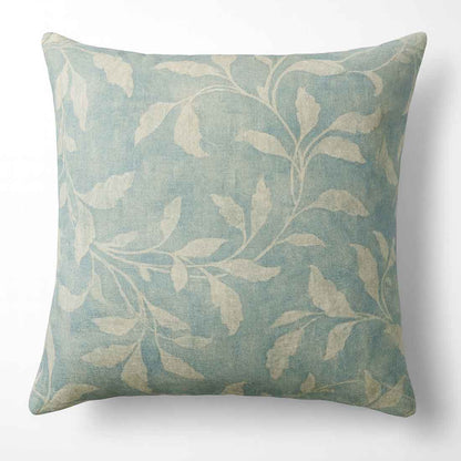 Decorative pillow with leaf patterns on a white background