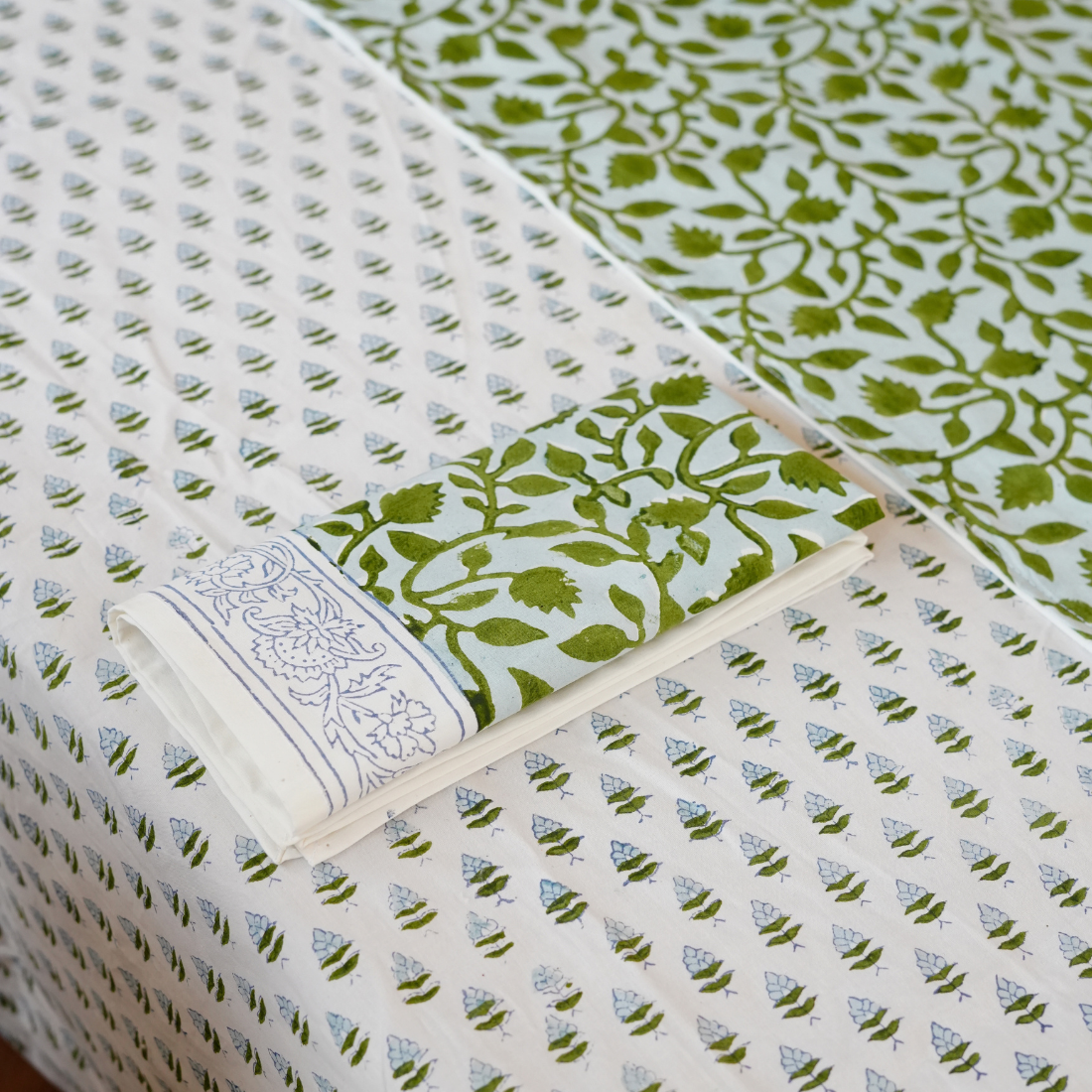 Collection of patterned fabric swatches in green and white.