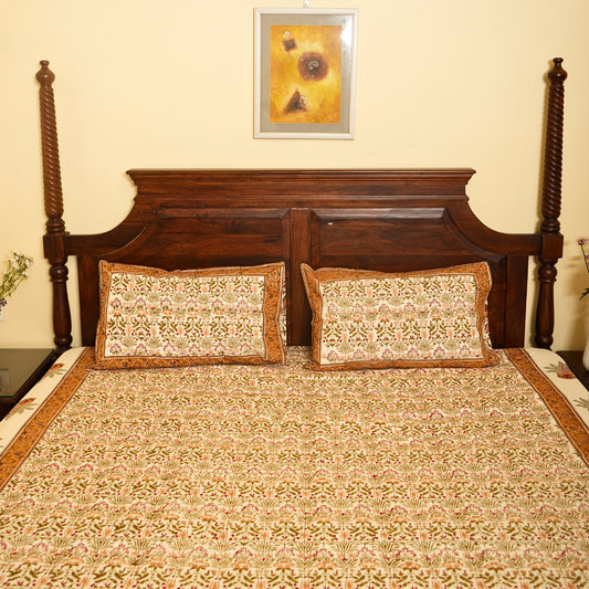Bed with wooden headboard and patterned bedding, framed picture on wall.