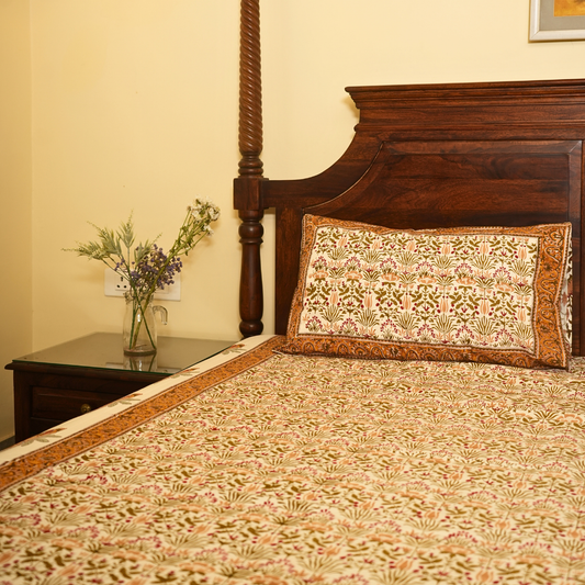 Bed with floral bedding and pillow, nightstand with flowers, and wooden headboard.