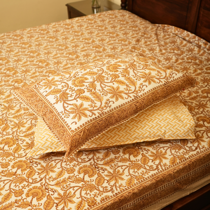 Decorative pillows with floral patterns on a matching fabric background