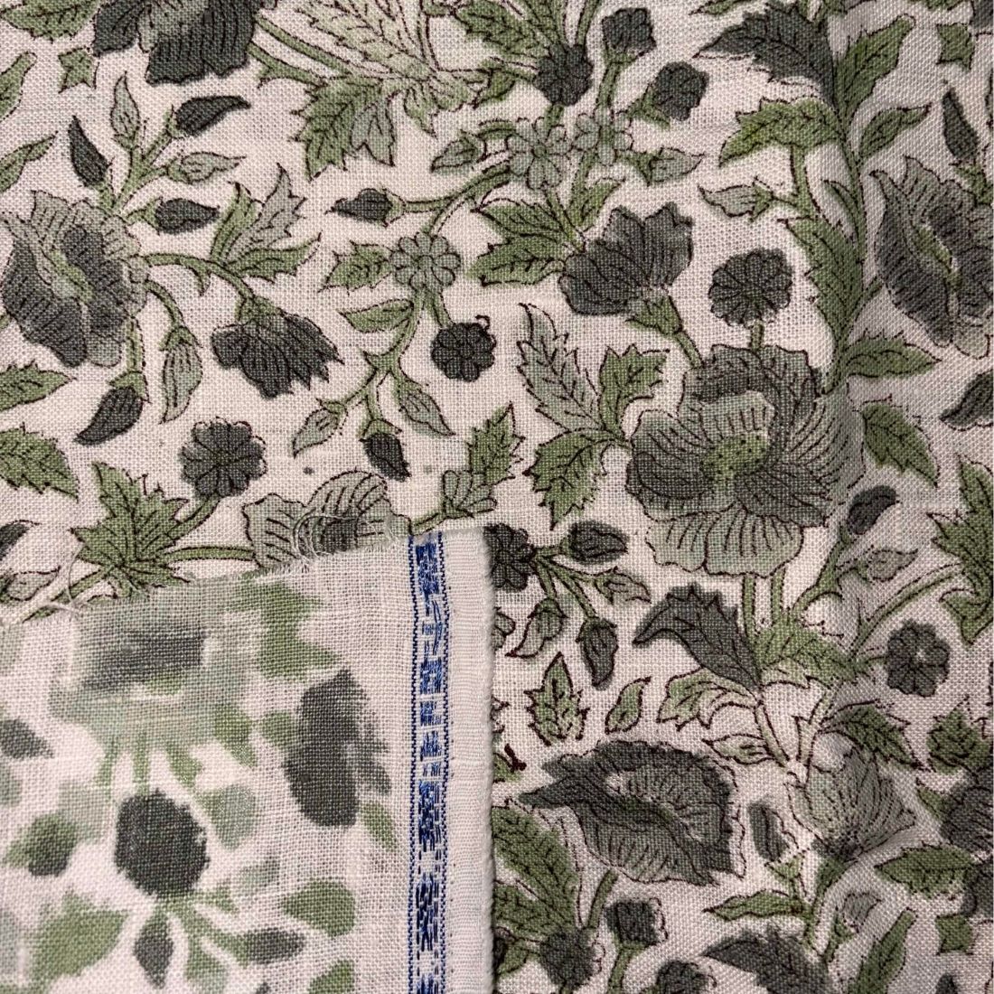 Floral patterned fabric with a ruler for scale on a grey background
