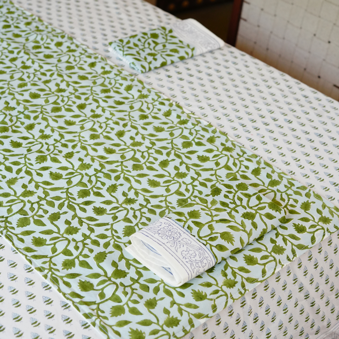 Green and white patterned fabric on a textured surface