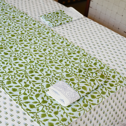 Green and white patterned fabric on a textured surface