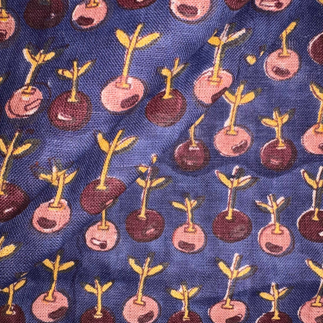 Patterned fabric with plant-like designs on a blue background