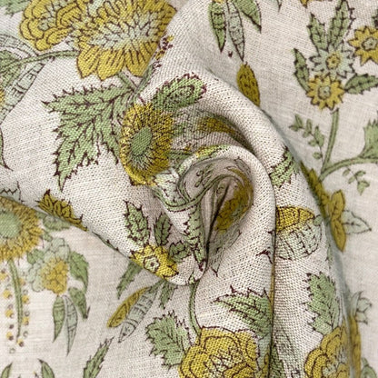 Close-up of floral fabric with yellow and green flowers on a grey background