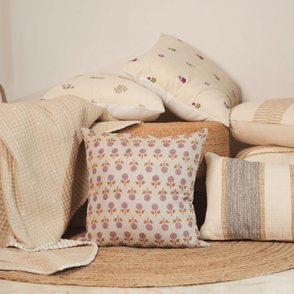 Decorative pillows with floral patterns on a woven surface