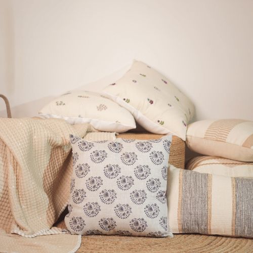 Patterned pillows on a sofa with a neutral background